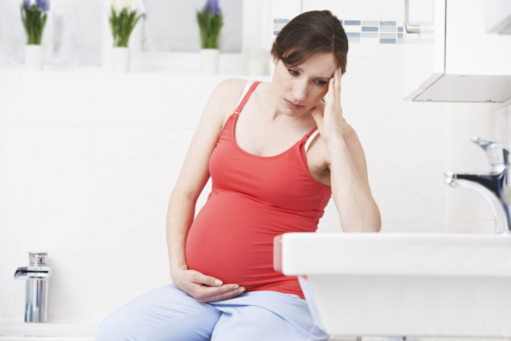 Pregnant woman experiencing nausea